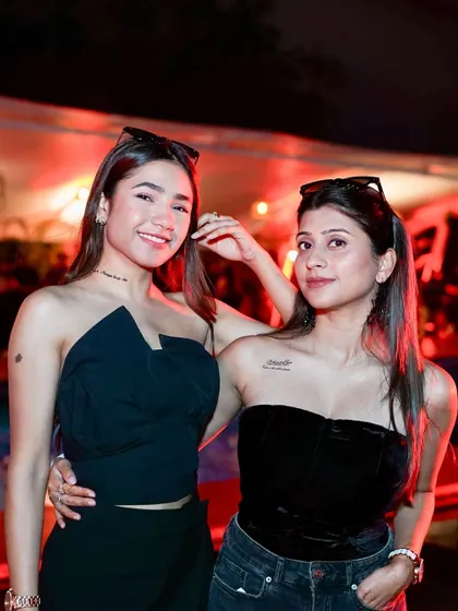 Two friends posing by the pool, enjoying the unique Halloween Sundowner experience.