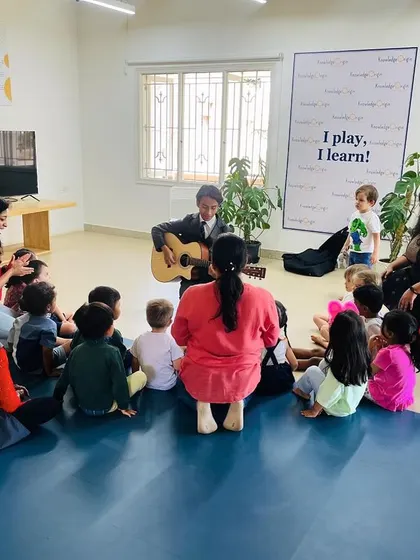Another view of our music class, showing how we create an intimate and interactive atmosphere. The children are gathered close, listening and getting ready to sing.