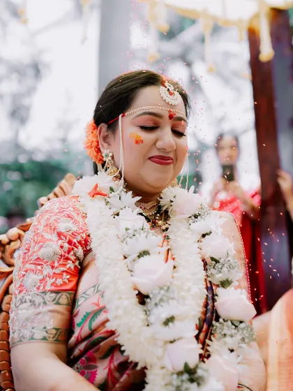 A happy, candid moment of the bride during a wedding ceremony ritual.