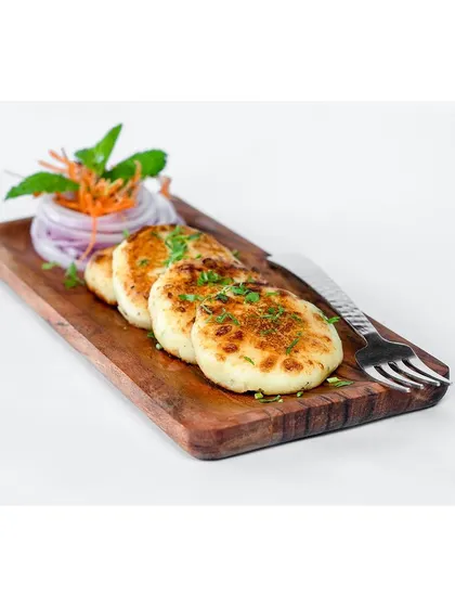 A clean, angled shot of the dahi ke kebab platter. This straightforward presentation is perfect for a standard menu listing, clearly showing the dish and portion size.
