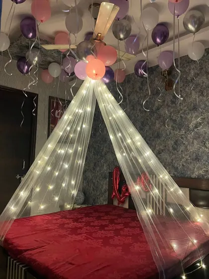 A simple and dreamy birthday bedroom decor. I used a fairy light canopy to create a focal point over the bed, with pink, purple, and silver balloons floating on the ceiling for a soft, celebratory feel.