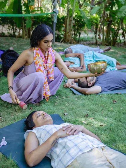 I offer a moment of deep relaxation with a singing bowl during an outdoor sound healing session. This personal, focused attention is a key part of the experience, allowing each individual to receive the healing vibrations of sound in a serene, natural setting.
