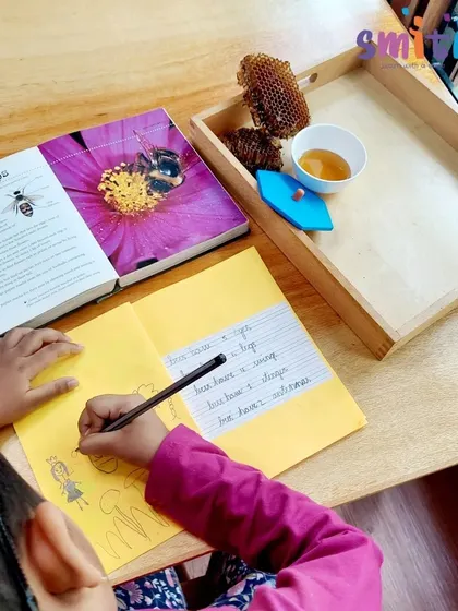 A student writes and draws about bees in her journal after the lesson. This helps her process and document her new knowledge.