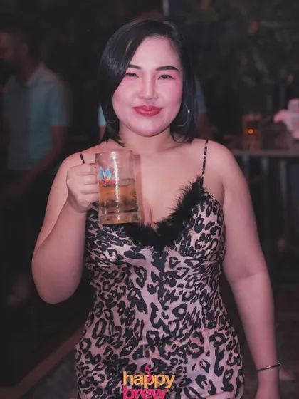 A happy guest enjoying a drink during our Thursday karaoke and DJ night. Creating a fun and welcoming atmosphere is key.