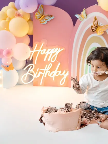 A wide view of the messy but happy scene. Cake smash sessions are designed to be fun for the baby and create lasting memories for the family.