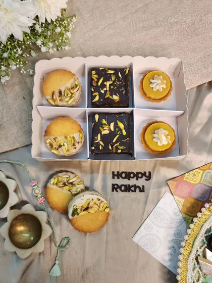 A delightful assortment for Rakhi, this box contains Pistachio Sandwich Cookies, Kunafa Brownies, and my special fusion Moongdal Tarts. It's a perfect blend of modern and traditional flavours.