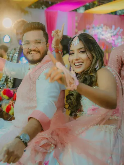 The Haldi couple dancing, her hair styled for movement and fun.