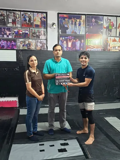 Another one for the team. Celebrating a student's success at a grappling competition. The hard work in the gym always shows on the competition mats.