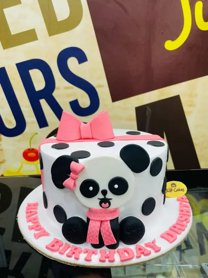 A cute 2kg panda cake with a polka-dot design and a big pink bow.