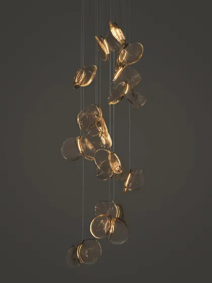A cascading installation of the Bocci 141 series, with the pendants appearing to float downwards like falling leaves.