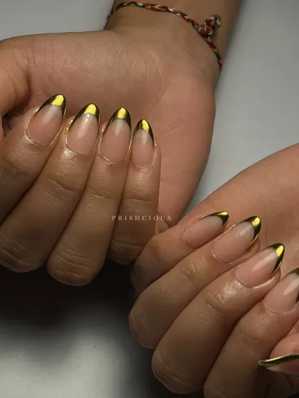 Chrome tips are always a win. This is a modern and chic take on the classic French manicure, using a solid gold chrome for the tips on long, almond-shaped nails.