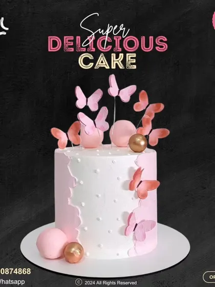 A delicate and pretty butterfly cake. This design features a soft pink and white color scheme, adorned with pink butterflies and shimmering gold and pink spheres.