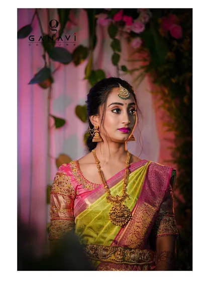 A stunning portrait of Rachita on her engagement day. Her lime green and pink saree is paired with a custom blouse featuring delicate embroidery on sheer sleeves, creating a dreamy and romantic look.