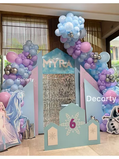 A wide shot of the beautiful 'Frozen' backdrop, featuring Elsa, Olaf, and a personalized name sign for Myra.