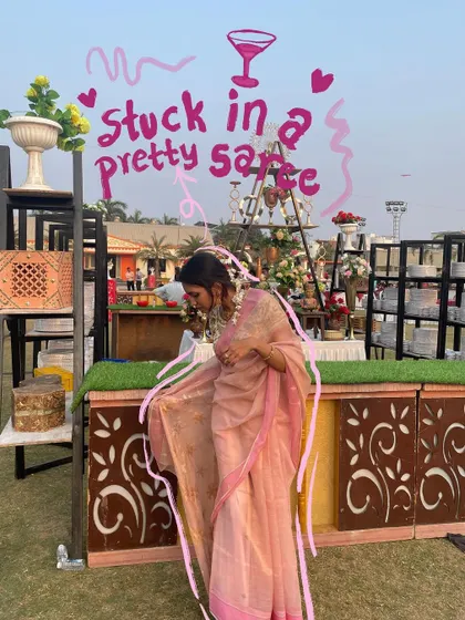 Stuck in a pretty saree, and not mad about it. The pink doodles and text add a fun, fashionable touch.