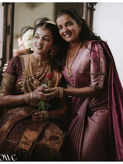 A sweet moment between the bride and her sister, sharing a hug and a smile.