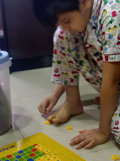 A candid shot of my son playing with letter tiles. This hands-on approach to learning words makes the process of spelling and reading much more intuitive and enjoyable for him.