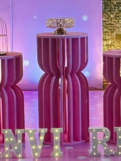A close-up of unique pink grooved pedestals and personalized marquee letters.