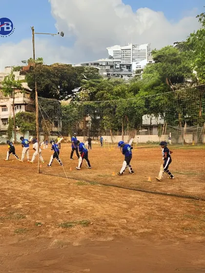 A wide shot of our players engaged in net practice on a classic dirt pitch. This image shows multiple players training simultaneously, reflecting the structured and busy environment of our academy.
