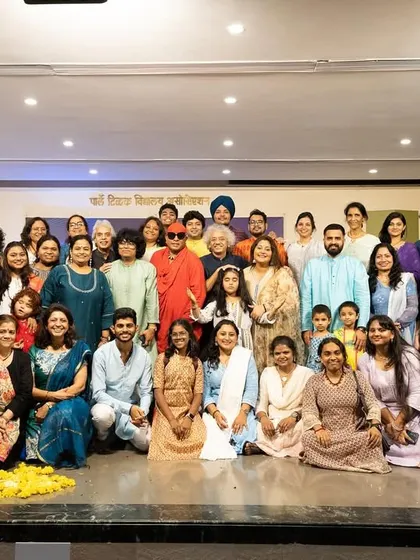 A group photograph with all the performers, guests, and students at the end of a successful Guruvandan. This picture captures the sense of community and shared joy that music brings.