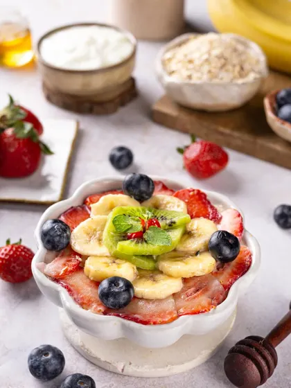 A healthy and colorful breakfast bowl with fruits and oats, styled to look vibrant and energizing.