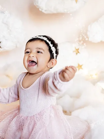Let's bring your creative ideas to life! For little Taarika's first birthday, we created this dreamy "above the clouds" setup right in her home. It was a star-studded shoot for a little star, showing how we can design a unique and personal session for you.