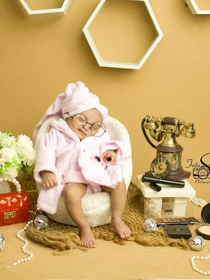 A different take on the 'Luxury Baby' theme. This sleeping newborn looks so peaceful and pampered, surrounded by vintage props and makeup accessories. It's a fun, creative, and completely unique newborn portrait.