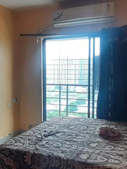 This bedroom's earlier window-side view shows the existing bed, curtains and yellow walls before our window and room transformation.