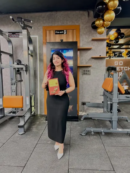 Holding my award at the gym. This recognition fuels my mission to spread positivity and make fitness accessible and enjoyable for everyone, which is the core of my nutrition coaching service.