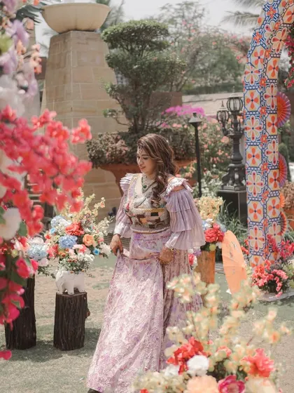 The bride enjoying her Mexican-themed Mehendi party. The colorful floral decor and the vibrant atmosphere make for beautiful, candid moments like this.