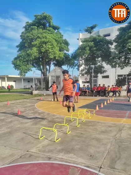 Agility ladder and hurdle drills on the basketball court, showcasing our use of different facilities to improve footwork and coordination.