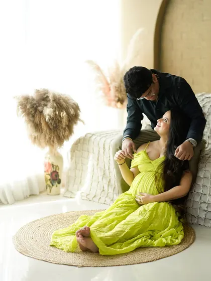 A playful and loving interaction between partners, with a pop of bright lime green adding a fresh, modern feel to the portrait.