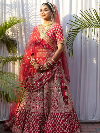 A full-length shot of a stunning bride. Her hands, adorned with my henna, are an integral part of her complete, regal look from head to toe.