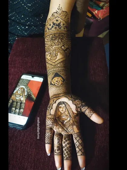 Capturing the bride's portrait from a reference photo. I take great care to replicate the details of the bride's attire and expression in my henna art.