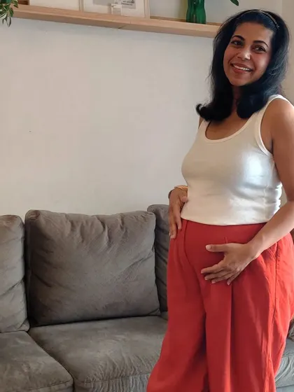 A simple ribbed tank top paired with vibrant, comfortable wide-leg pants. This is a great example of using color and simple basics from your existing wardrobe for bump-friendly styling.