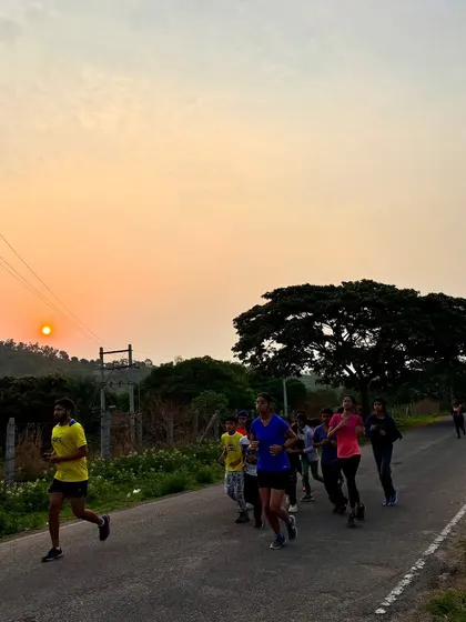 Campers on a morning jog along a scenic road as the sun rises. Physical fitness is a key component of our youth leadership camps, building endurance and discipline.