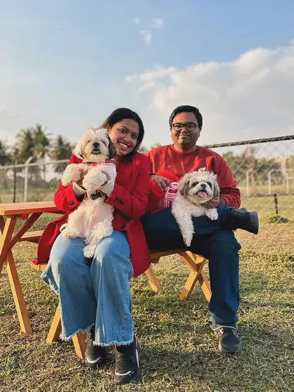 Double the fluff, double the fun! This couple is enjoying a day out with their two Shih Tzus.