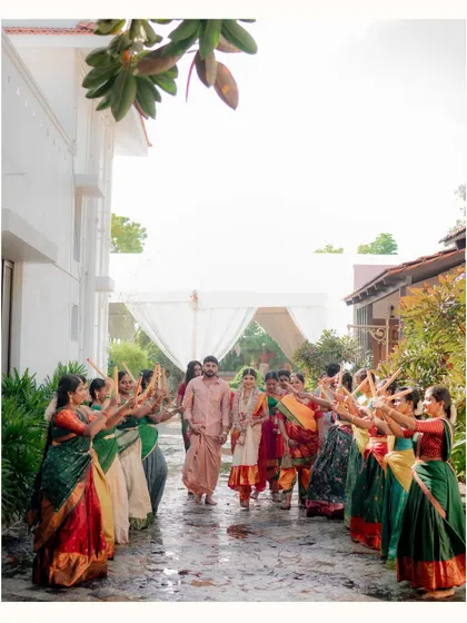 The bride and groom's entrance together, welcomed by a row of dancers. A beautiful, coordinated moment from Varun and Priya's wedding.