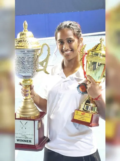 Holding up the trophies for the Open Women's Singles and Mixed Doubles wins. Competing at this level helps me provide the most current and effective coaching for players aiming for tournament success.