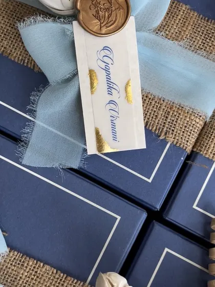 A detail shot of our sustainable Diwali gifting collaboration. The personalized tag with gold foil detailing, frayed ribbon, and wax seal adds a touch of luxury to the eco-friendly packaging.