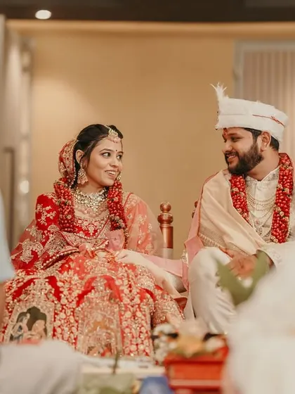 The bride and groom share a sweet glance during their wedding ceremony, a candid moment full of love.