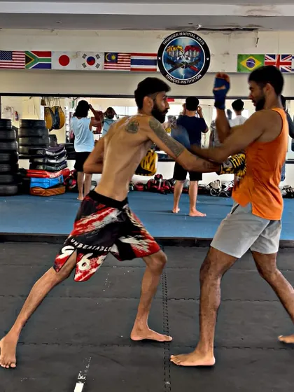 Two students exchange punches during a sparring drill. This helps build timing, accuracy, and defensive reflexes.