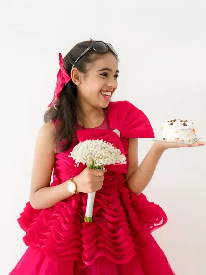 A stylish and fun portrait of the birthday girl with her cake, flowers, and sunglasses. We can incorporate props that reflect your child's personality.