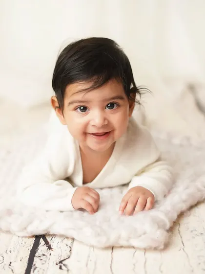 A happy baby boy during his tummy time session. This is a great milestone to capture when they have strong head and neck control.
