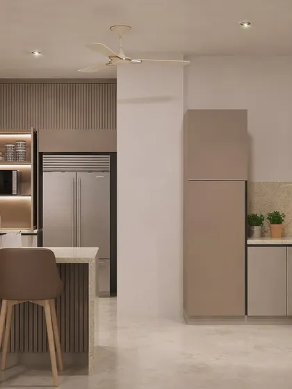 This wider angle shows how the kitchen connects to the rest of the living space. The design uses a consistent color palette and under-cabinet LED lighting to ensure the kitchen feels both functional and cozy.