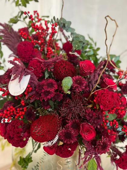 The deep reds and interesting textures in this arrangement make it perfect for the holiday season or a Valentine's Day surprise. It's a bold statement of passion and gratitude for flowers.