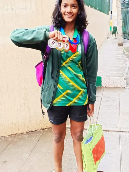 Kavya Karthik, one of our talented young swimmers, with her gold and silver medals after the Splash N' Dash competition.