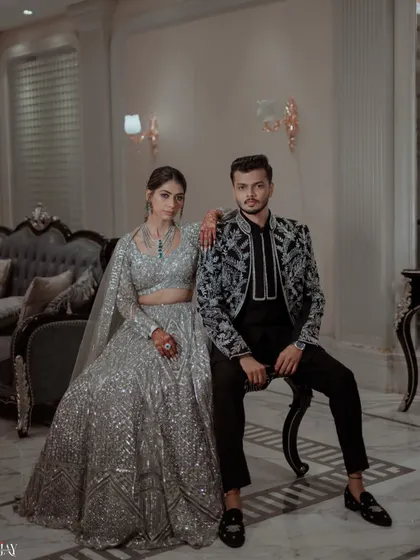 A powerful and stylish portrait of the couple in their coordinated silver and black Sangeet outfits.