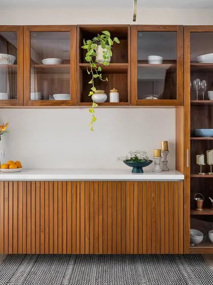 A beautiful floating crockery unit with fluted wooden panels and glass-fronted upper cabinets. The design is both elegant and practical, providing plenty of storage without taking up floor space.