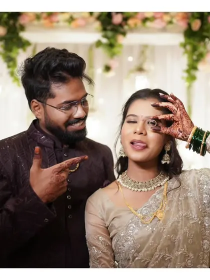 A fun and quirky pose from an engagement ceremony, showing the couple's playful side.